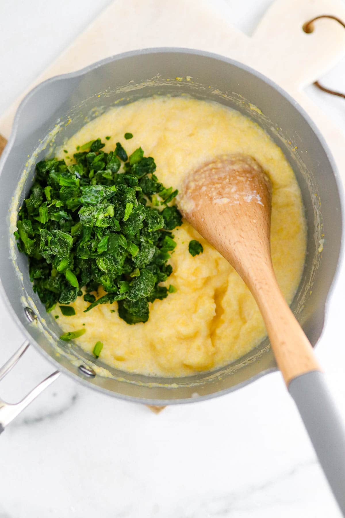 Polenta in the cooking process, adding spinach
