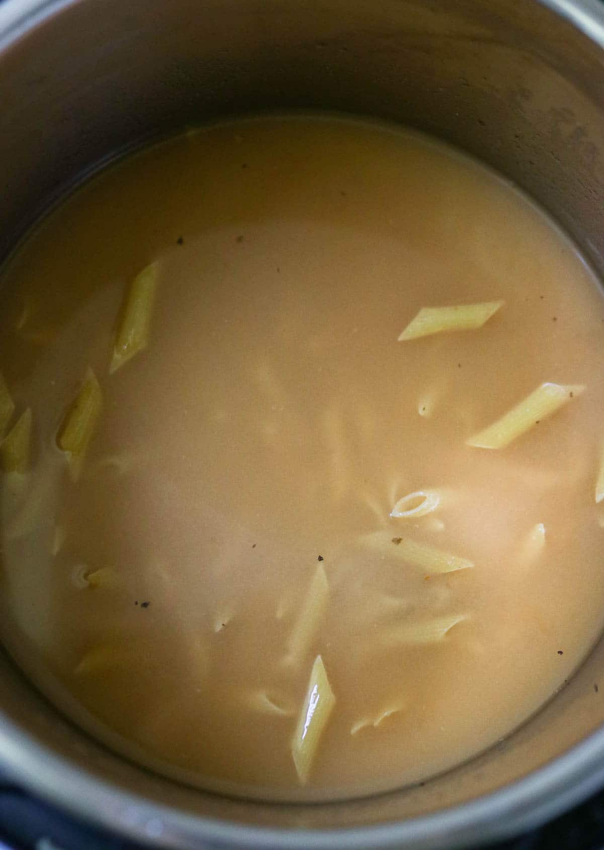 photo of uncooked pasta in broth in the Instant Pot