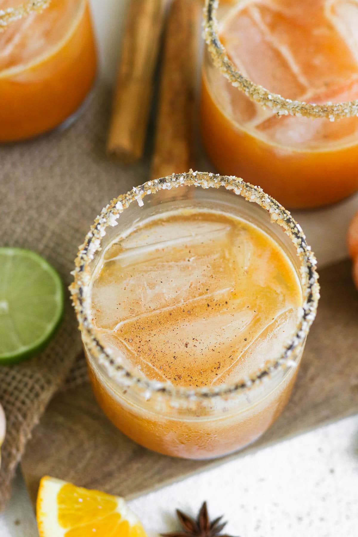 close up of pumpkin margarita with salted rim and garnishes.