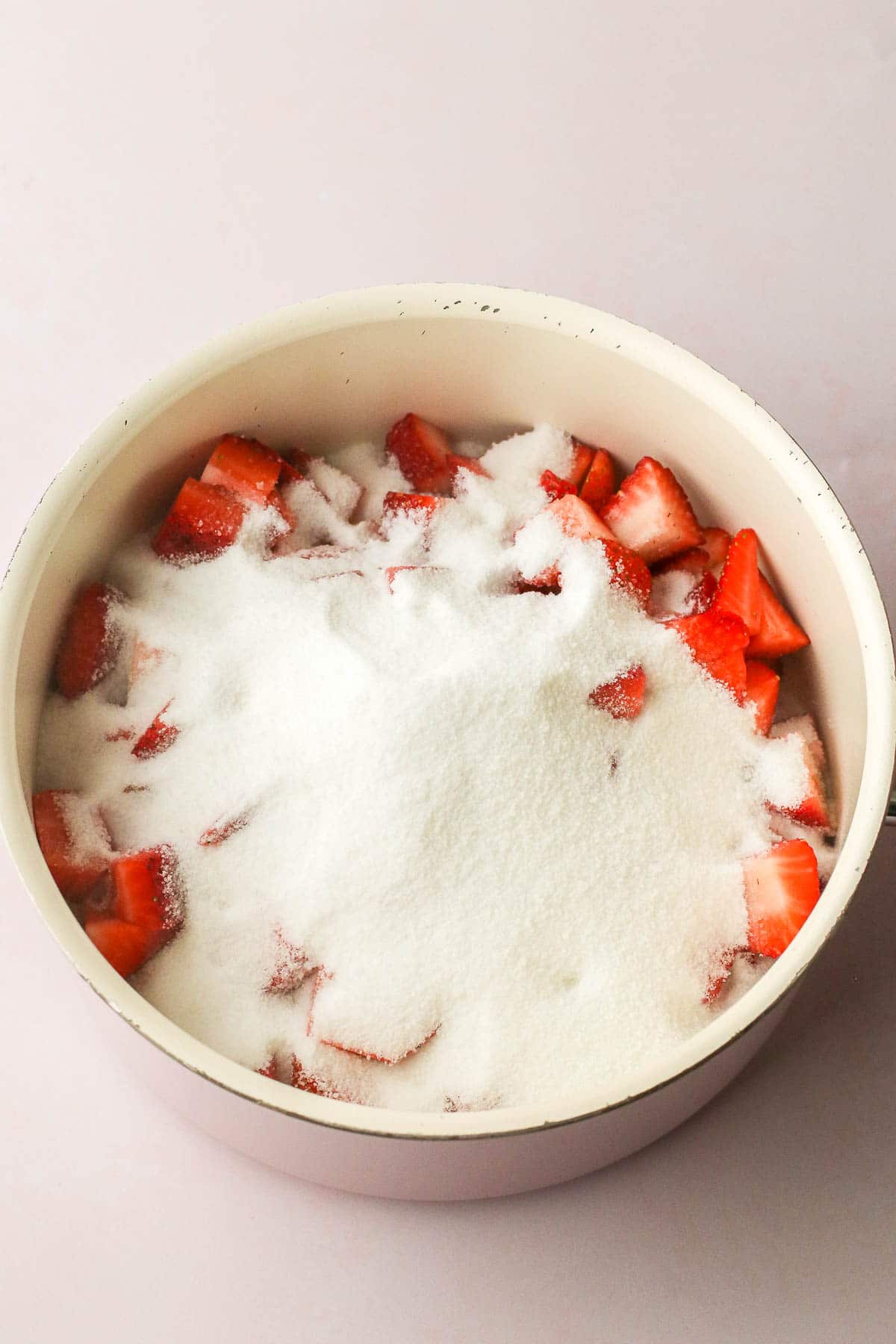 sugar and strawberries in a pot.