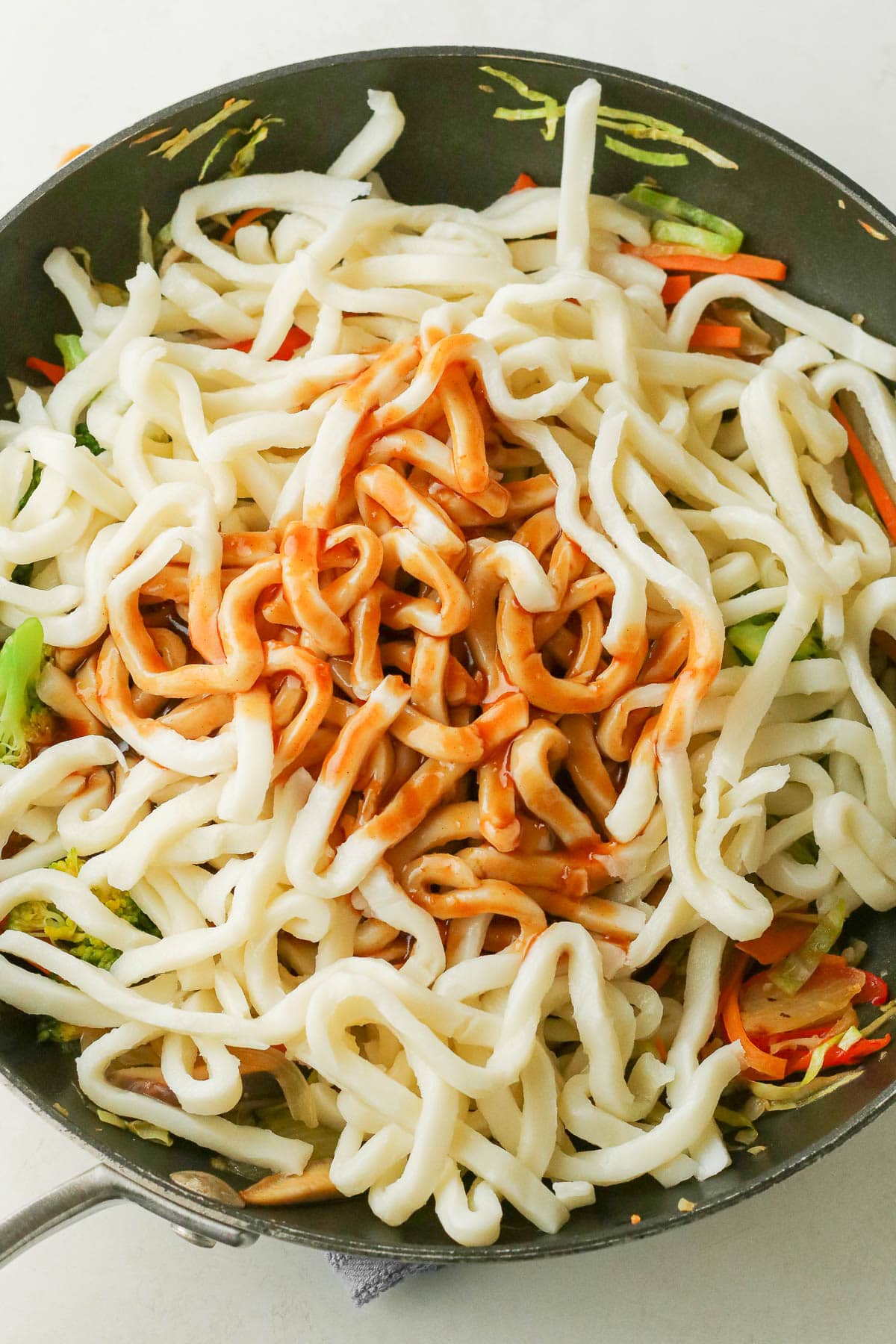 Noodles added to pan with sauce.