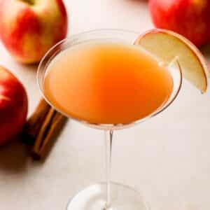 martini in a glass with apples around.