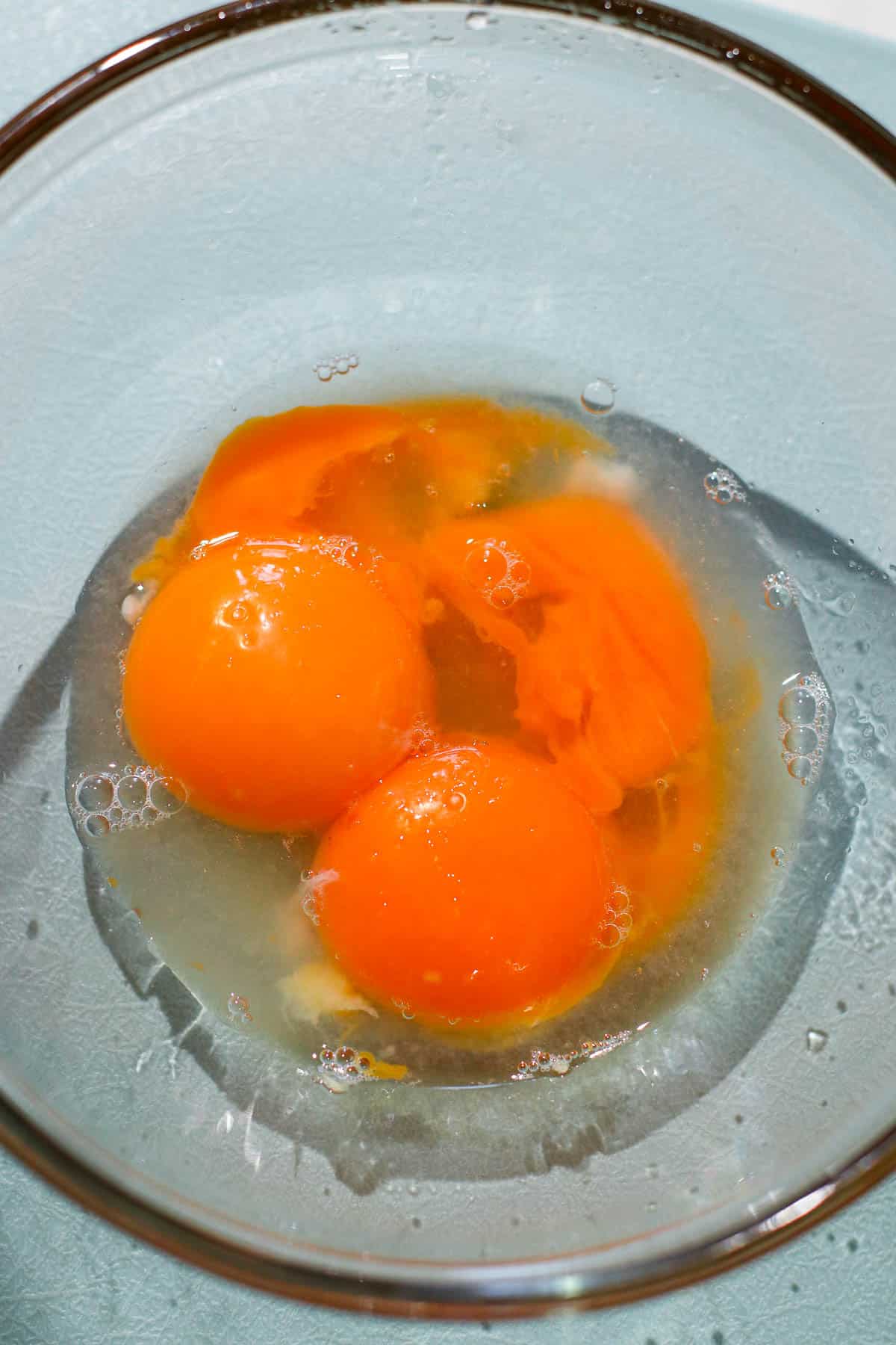 yolks with juice and garlic in a bowl.