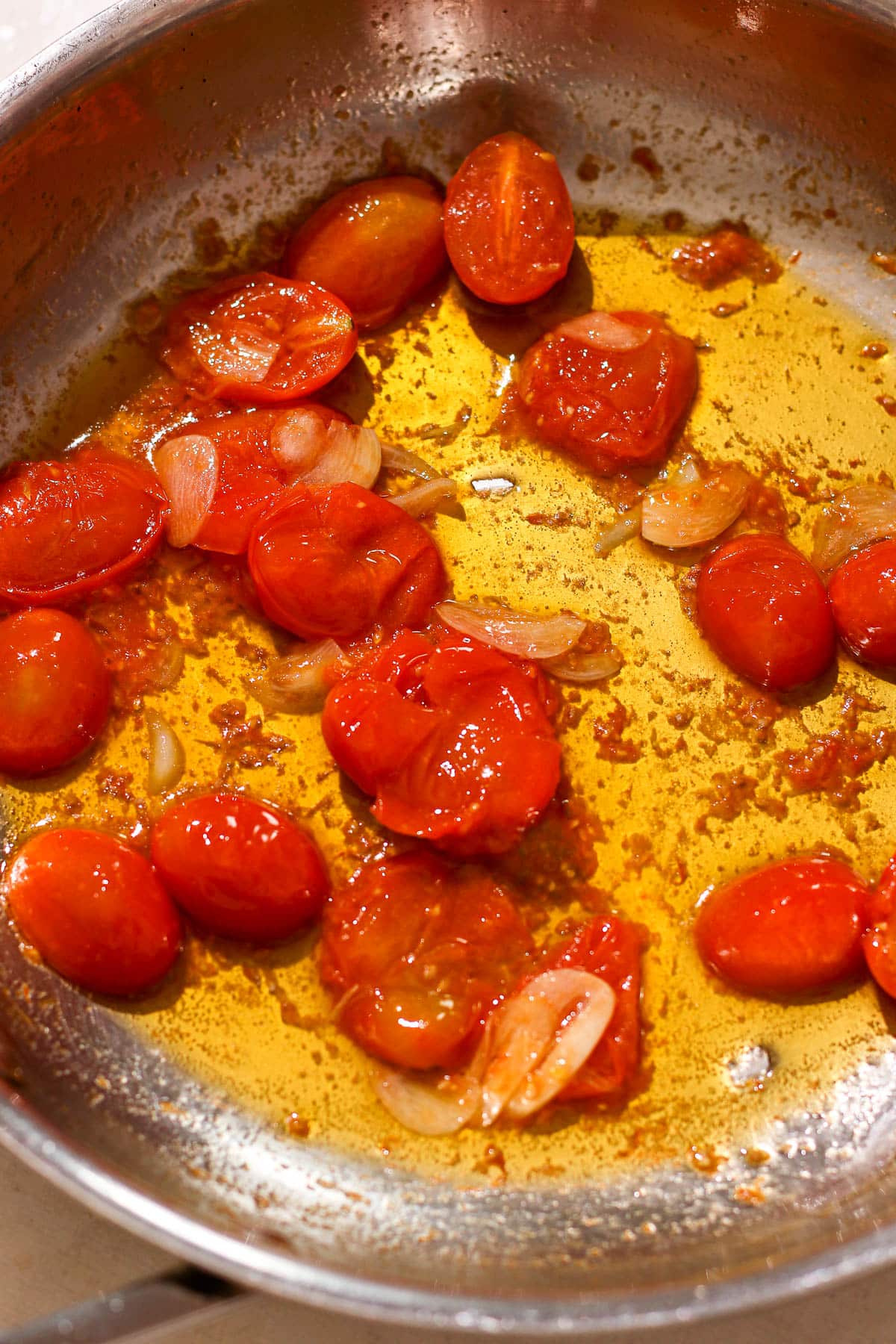 cooked tomatoes and garlic in pan.