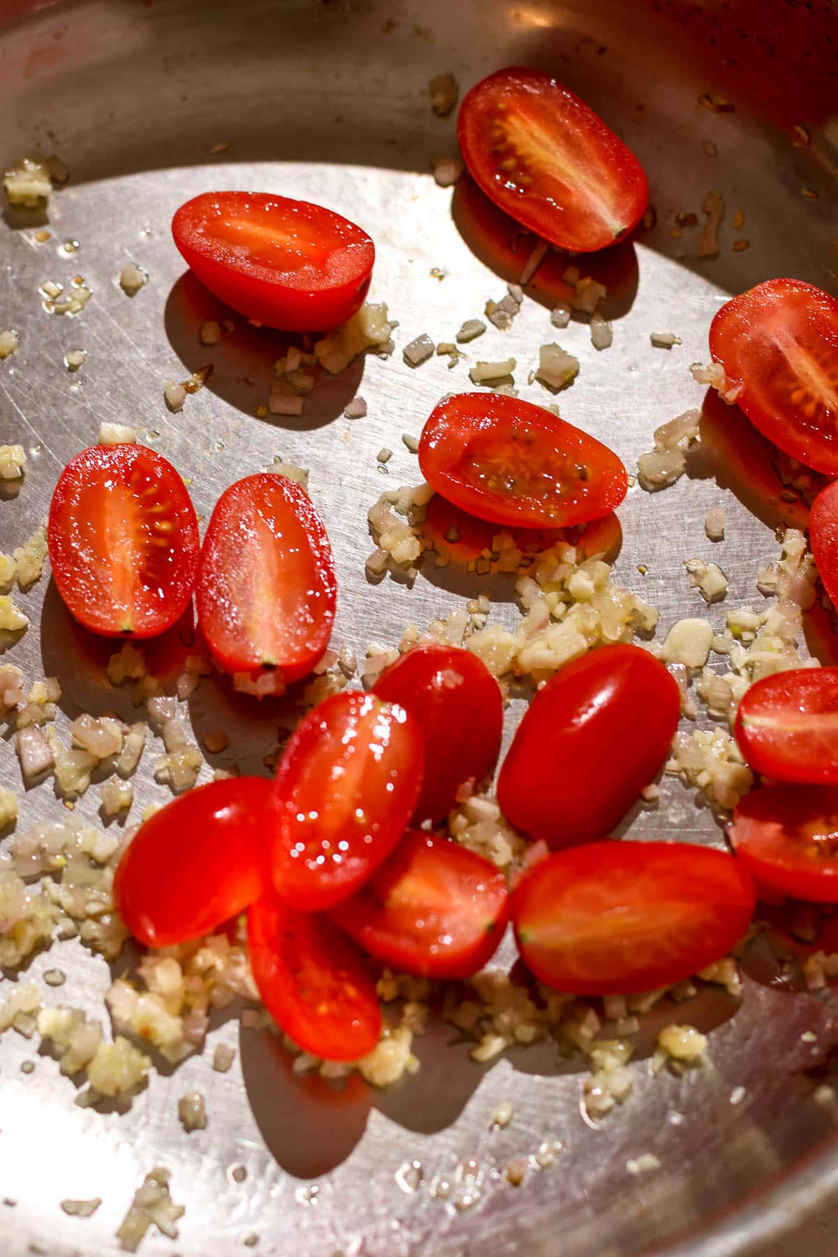 garlic, shallot, tomatoes in a pan.