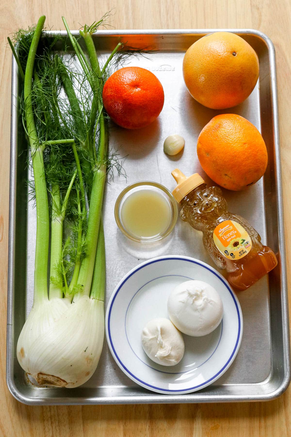 ingredients for salad on a silver tray.